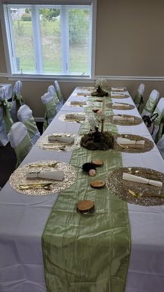 a long table is set up with plates and place settings for guests to sit at