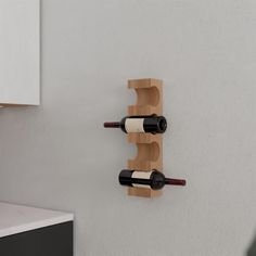 two bottles of wine are placed on the wall