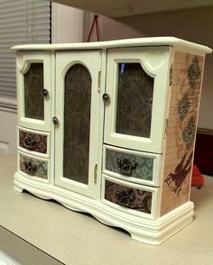 a white cabinet sitting on top of a counter