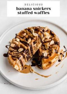 a white plate topped with waffles covered in peanut butter and chocolate drizzle