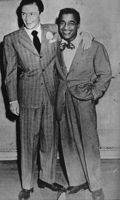 two men in suits standing next to each other