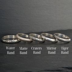 five different types of rings sitting on top of a black table next to each other