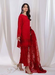 Stand out in this elegant outfit, meticulously crafted from a remarkably glamourous shade of red with its intricate hand-crafted details, with intricate embroidery on the dupatta intertwines with the fabric, forming floral motifs strikes the perfect balance between elegant and eye-catching, making this beautiful design a must have. Shirt: Self JacquardPants: Self JacquardDupatta: Organza Red Chikankari Embroidery Sharara For Designer Wear, Summer Designer Wear Red Sets, Elegant Red Sharara For Designer Wear, Red Georgette Sets With Dupatta, Elegant Red Unstitched Suit In Chinon, Elegant Red Unstitched Chinon Suit, Elegant Red Chinon Unstitched Suit, Red Silk Dupatta With Dabka, Elegant Red Sharara With Sheer Dupatta