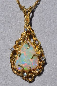 The Cicero: Ladies Brutalist Style 14K Yellow Gold Opal and Diamond Pendant. Beautifully handcrafted in 14 karat yellow gold is this 2-inch x 1-inch vintage pendant. The pendant is set with an approximate 20 x 15 x 4mm Australian opal that portrays excellent play of color. The pendant is also set with 0.30 carats of diamonds and features a large rabbit ear style bail. Purchase the pendant as is or inquire about purchasing a yellow gold chain to pair with this magnificent piece. Love this piece, Unique Yellow Gold Collectible Jewelry, One Of A Kind Oval Yellow Gold Jewelry, Exquisite Gold Necklace For Collectors, Exquisite Yellow Gold Jewelry With Large Pendant, Exquisite Gold Jewelry Collectible, Unique Pear-shaped Gold Jewelry, Handmade Yellow Gold Pear-shaped Jewelry, Handmade Pear-shaped Yellow Gold Jewelry, Antique Gold Pear-shaped Jewelry