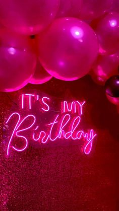 it's my birthday neon sign and balloons on the floor in front of them