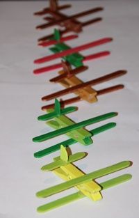 several toothpicks lined up in the shape of arrows on a white tablecloth