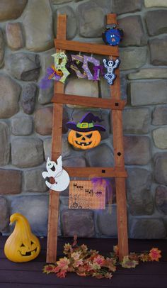 a wooden ladder decorated with halloween decorations