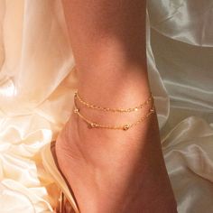 "Shine with our Ball Chain Shiny Anklets, a dazzling addition to your ankle jewelry collection. These anklets feature a double-layering design, adding a stylish touch to your look. Personalize them with a gold initial charm, creating a unique and meaningful piece. #YOU MAY LIKE THIS Birth stone anklet  https://www.etsy.com/listing/1516443730/birth-stone-anklet-gold-paper-clip-chain Initial flower anklet  https://www.etsy.com/listing/1503835978/initial-flower-anklet-cute-dainty-hand #HOW TO ORDER Layering Design, Stone Anklet, Anklet Gold, Ankle Jewelry, Gold Paper, Gold Initial, Cute Bracelets, Keep Jewelry, Initial Charm