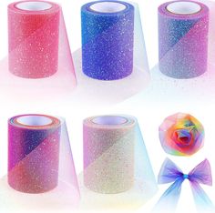 several rolls of colorful glitter tape with a bow on each side and one roll in the middle