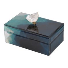 a blue and black box with a white rock on top