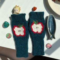 two knitted mittens sitting on top of a table