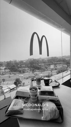 a tray with food and drinks on it in front of a mcdonald's sign