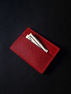 A tiny red Buttero Hatch leather wallet that will easily fit in most pockets. Crafted from red Buttero Hatch leather, this tiny accessory showcases a small coin pouch and slot for a card or two. It can also be used for some cash - an ideal variant for minimalists seeking to carry as little as possible. What is Butter Hatch leather? It is vegetable tanned leather produced by one of the most famous tanneries in the world called Walpier. The leather is prized for its quality and authentic look. It Red Leather Card Holder With Interior Slots, Red Leather Card Holder For Daily Use, Red Leather Coin Purse With Card Slots, Red Leather Bifold Coin Purse, Red Leather Business Card Holder, Red Leather Everyday Card Holder, Red Rectangular Coin Purse With Card Slots, Red Rectangular Coin Purse With Interior Card Slots, Rectangular Red Coin Purse With Interior Card Slots