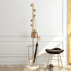 a pair of shoes and an umbrella stand in front of a white wall with a wooden floor