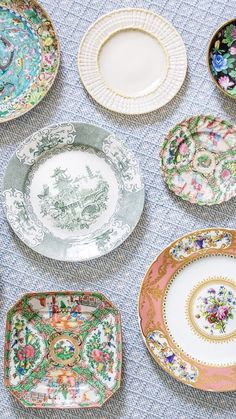 there are many plates that have different designs on them, all in different colors and sizes