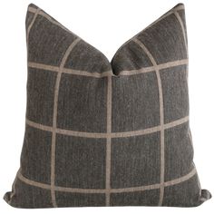 a gray and brown checkered pillow on a white background