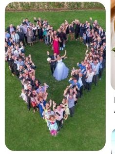 a large group of people standing in the shape of a heart on top of grass