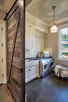 an open door leading to a kitchen with a washer and dryer