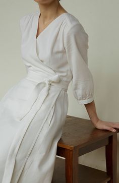 "Classic and timeless muslin wrap dress with pockets, lining and very cute and simple sleeves. Tea length makes this dress very classy. You can use it as a summer wedding dress. This cotton dress is ties on a belt so and you can wrap this dress over your waist and fit it like you desire. Muslin is a breathable, very flexible and gentle material. The lining in the dress is also made of 100% organic cotton, which will allow your body to breathe both on hot days of summer and in the cool weather of spring or autumn. DETAILS:  ⁃ Deep V-neck  ⁃ 3/4 sleeves  ⁃ Wrap design  ⁃ Tied waist  ⁃ Midi length (~115cm/45,3\")  ⁃ Full lining, so dress will be not transparent Measurements for size XS: - BUST 80-84cm / 32\" - 33\" - WAIST 60-66cm / 24\"- 26\" - HIPS 84-90cm / 33\"- 35\" Measurements for size Muslin Dress Women, Minimalist Summer Wedding, Modesty Dress, Summer Dresses With Sleeves, Sunday Dresses, Gown Simple, Classical Dress, Puff Sleeve Gown, Muslin Dress