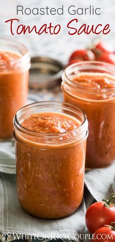 three jars filled with tomato sauce sitting on top of a blue and white table cloth