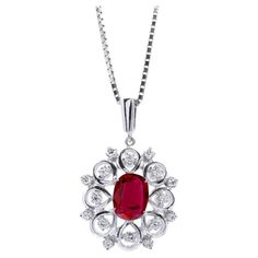 At the heart of this pendant lies a vibrant, fiery crimson center stone, embodying energy and passion. The 1.15 carats Ruby, cut in an elegant oval shape, brings this pendant to life. To enhance its vivid color, the Ruby has been carefully heated, showcasing its natural beauty while maintaining an eye-clean appearance. Encircling this captivating Ruby are diamonds thoughtfully positioned to create a delightful flower motif. This pendant makes a perfect gift choice for birthdays or anniversaries, Platinum Pendant, Flower Motif, Platinum Metal, Ruby Gemstone, Red Ruby, Vivid Color, Belleza Natural, Natural Red, Oval Cut