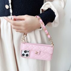 a woman holding a pink purse and cell phone