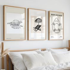 three framed pictures hang on the wall above a bed with white linens and pillows