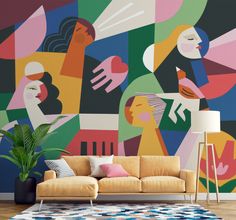 a living room scene with focus on the sofa and colorful wallpaper that has abstract shapes