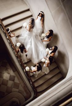 a bride and her bridal party walking down the stairs at their wedding ceremony in chicago, illinois