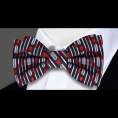 Unveiling the Black, Red, and Silver Silk Bow Tie: Your Style Upgrade In the realm of men's fashion, there exists a pinnacle of elegance that transcends time and trends—the silk bow tie. Today, we present to you the epitome of refined sophistication: the Black, Red, and Silver Silk Bow Tie. With its mesmerizing lines and dots pattern, this accessory is more than just an embellishment; it's a statement piece that speaks volumes about your impeccable taste and style. Craftsmanship and Quality: Cra Black Bow Tie For Summer Party, Red Bow Tie For Formal Summer Events, Elegant Red Suit And Tie Accessories For Summer, Red Bow Tie For Black Tie Occasions, Red Bow Tie For Formal Occasions, Red Formal Suit And Bow Tie Accessories, Black Bow Tie For Black Tie Events, Black Ties As A Summer Gift, Black Summer Formal Ties