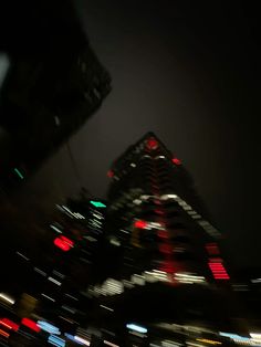 blurry photograph of city buildings at night