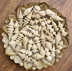 several pieces of carved ivory are arranged in a circular pattern on a wooden table top