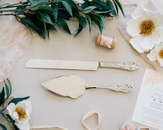 there are some silverware and flowers on the table