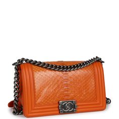 This medium Chanel Boy Bag is in orange python leather with aged ruthenium hardware, a front flap with Le Boy CC push closure, one slip pocket on back wall, and aged ruthenium chain link and orange leather shoulder strap.The interior is lined in orange leather and has one open slit pocket on the rear wall.Collection: 19-series (2014)Origin: FranceCondition: Pre-owned; Excellent to Mint - This bag retains its shape. The exterior leather has some minor light wear around the corners of the bag. There's no plastic on the hardware and no signs of scratches. The interior leather is clean with signs of wear and the date stamp sticker is still intact.Accompanied by: Chanel box, Chanel dustbag and COA CardMeasurements: 9.5" width x 6" height x 3.5" depth; 22" strap drop (12" doubled) Chanel 2014, Chanel Box, Quilted Wallet, Small Boy, Chanel Shoulder Bag, Orange Bag, Orange Leather, Chanel Boy, Chanel Boy Bag