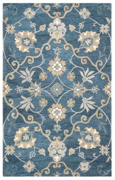 a blue rug with an ornate design on the front and back side, in various colors