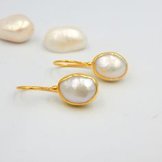 "White Fresh Water Baroque Pearl Drop Earrings. Sterling Silver 18k Gold Plated, 100% Handmade Unique Statement Earrings. PEARL: This enchanting June birthstone originates from oceans, lakes and rivers around the world. It is a timeless wardrobe staple, beloved by women of all ages. Pearls have long been associated with purity, humility and innocence. So it may be said that the June birthstone meaning is \"sweet simplicity.\" As such, pearls were traditionally given as a wedding gift. THE EARRIN Handmade Gold-plated Bridal Earrings For Wedding, Classic Pearl Earrings With Gemstone For Gift, Classic Pearl Gemstone Earrings As Gift, Wedding Gemstone Drop Earrings, Wedding Drop Gemstone Earrings, Oval Gold Plated Earrings For Wedding, Anniversary Bridal Earrings With Pearl Drop In Yellow Gold, Anniversary Bridal Earrings In Yellow Gold With Pearl Drop, Wedding Oval Pearl Earrings