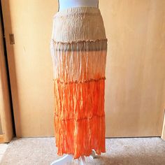 Nwt Sz S Gradient Boho Skirt For Essentials By Milano. The Material Is Crimped, Like An Accordian Fold. It Is Tie Dyed, Starting With Cream/Beige On Top And Darkening To Cream/Orange On The Bottom. Including The Top, It Has Four Tiers. The Skirt Is A Pull On With A Comfortable Elastic Waistband. It Is Unlined And Semi Sheer. Measurements Are 24-28 Inches Around The Waist, 38 Inches Free At The Hips, And 34 Inches Long. Orange Tiered Maxi Skirt For Vacation, Bohemian Orange Maxi Skirt For The Beach, Orange Tiered Lined Skirt, Bohemian Long Orange Skirt, Orange Relaxed Maxi Skirt For Beach, Orange Maxi Skirt For Summer, Orange Relaxed Fit Lined Maxi Skirt, Orange Maxi Skirt For Spring Beach Outing, Orange Maxi Skirt For Spring Beach Occasion