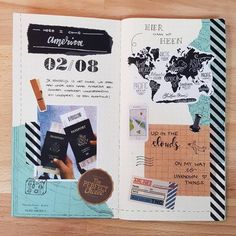 an open travel journal with stickers and other things on the pages, including passport stamps