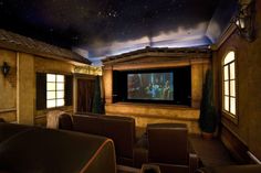 a home theater with leather seats and a projection screen