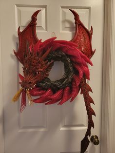 a red dragon wreath hanging on the front door