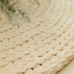 a close up view of a white crocheted rug