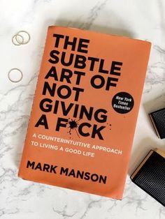 the subtle art of not giving a f k by mark mason on a marble surface