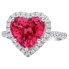 Fancy shaped Spinels are a rare find, and even more so with an intense fluorescent pink color. Cut to precision, this center gem is eye clean and has unmatched beauty. Each gem is held in place by strong platinum prongs making this ring just right to show your everlasting love for each other. LSK10006-SPIN #288525 Ring Overview SKU 516 Center Stone Spinel Side Stones Diamonds Metal Type Platinum Metal Weight 6.50 gr Report GRS Report Size 6.5 Center Stone Quantity 1 Total Weight 3.90 carats Color Purplish Pink Color intensity Strong Shape Heart Clarity Very eye clean Treatments None Dimensions 9.54 x 10.38 x 5.60 mm Diamonds Quantity Multiple Total Weight 0.40 carats Color White Color intensity G-H Shape Round Clarity VS2/SI1. Cut Brilliant Origin Belgium Treatments No Enhancement Pink Heart Rings, Spinel Jewelry, Heart Rings, Blue Gemstone Rings, Pink Spinel, Spinel Ring, Diamond Heart Ring, Heart Shaped Jewelry, Platinum Diamond Rings