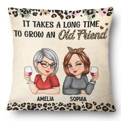 a pillow with two women holding wine glasses