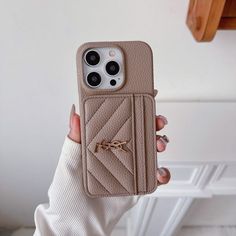 a woman is holding up her phone case