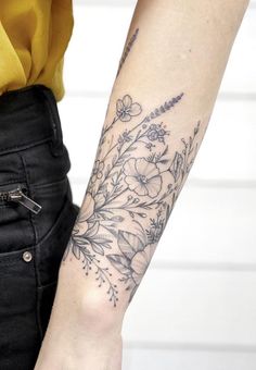 a woman with a flower tattoo on her arm