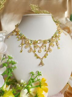 This is a captivating homage to the resplendent canola flowers ('Nanohana') that paint the Japanese landscape in springtime. Embrace the essence of fairy-core charm with this intricately crafted necklace, delicately weaving together hues of gold and green reminiscent of the verdant-gold fields at dawn. 🍃Handcrafted with citrine, prehnite, dyed green freshwater pearls, glass beads, and gold-plated findings. 🍃Measures about 39.5cm (15.5 inches), with 5cm extenders. Transform in to a forest fairy Fairy Wedding Jewelry, Fairy Core Necklace, Gold Floral Necklace, Fairycore Jewelry, Forest Necklace, Handmade Fairy, Pretty Jewelry Necklaces, Tiered Necklace, Fairy Wedding