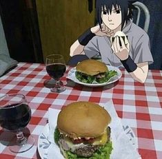 two hamburgers sitting on top of a white plate next to a glass of wine