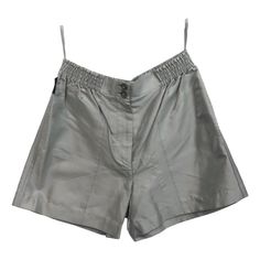 - Chanel silver metallic silk and nylon shorts from spring/summer 1999 collection. - Featuring two "Chanel Paris" plastic buttons front closure with elastic waistband. - Silver hardware "Chanel" zipper closure. - Flap button pocket at the back. - Two front slip side pockets. - Size 40 France. - 78% Silk, 22% Nylon. Elegant Short Silk Bottoms, Silver Metallic Shorts, Silver Bottoms With Built-in Shorts, Silver High-waist Shorts For Summer, Shiny Nylon Shorts, Hot Pants Shorts, Heart Tank Top, Chanel Suit, Vintage Chanel Bag