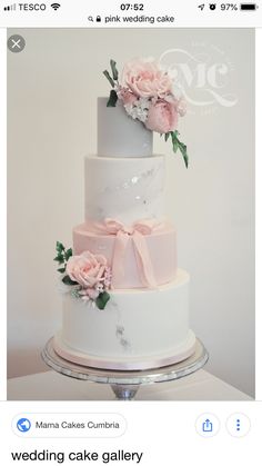 a three tiered wedding cake with pink flowers on top